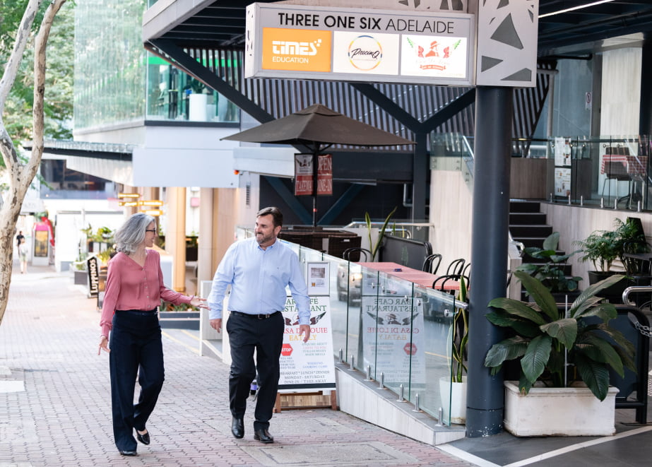 Mel and AJ walk down 316 Adelaide Street, Brisbane, the home of Exclaim IT.