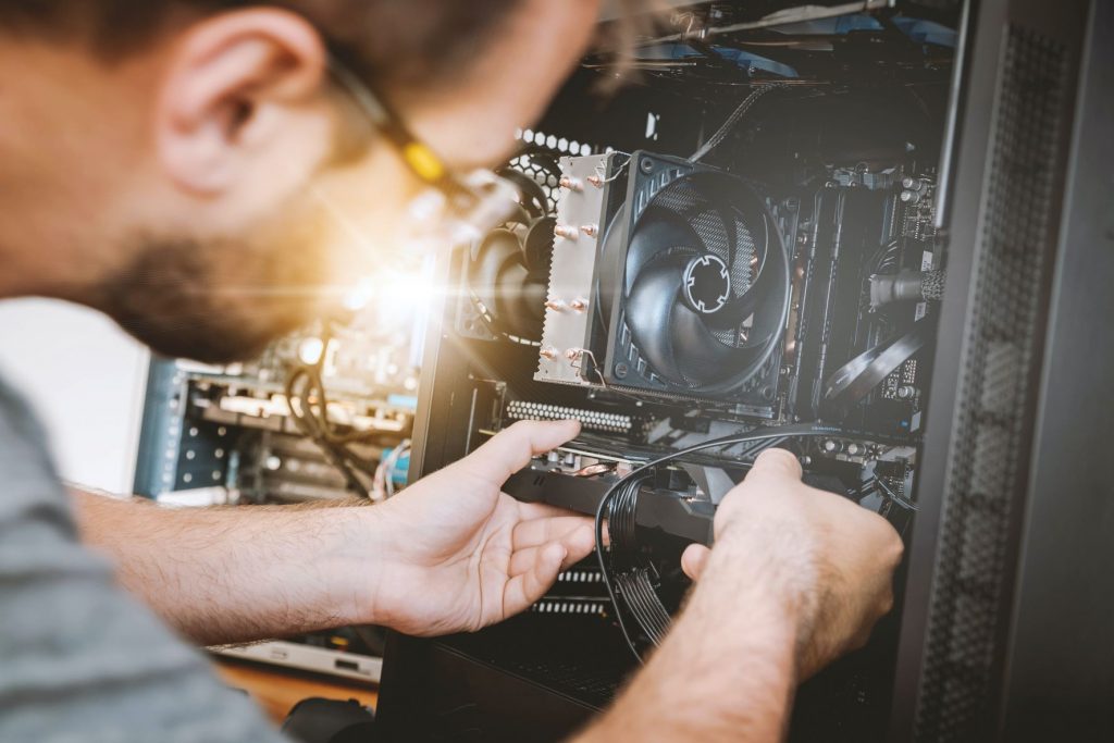 Man fixes computer hardware